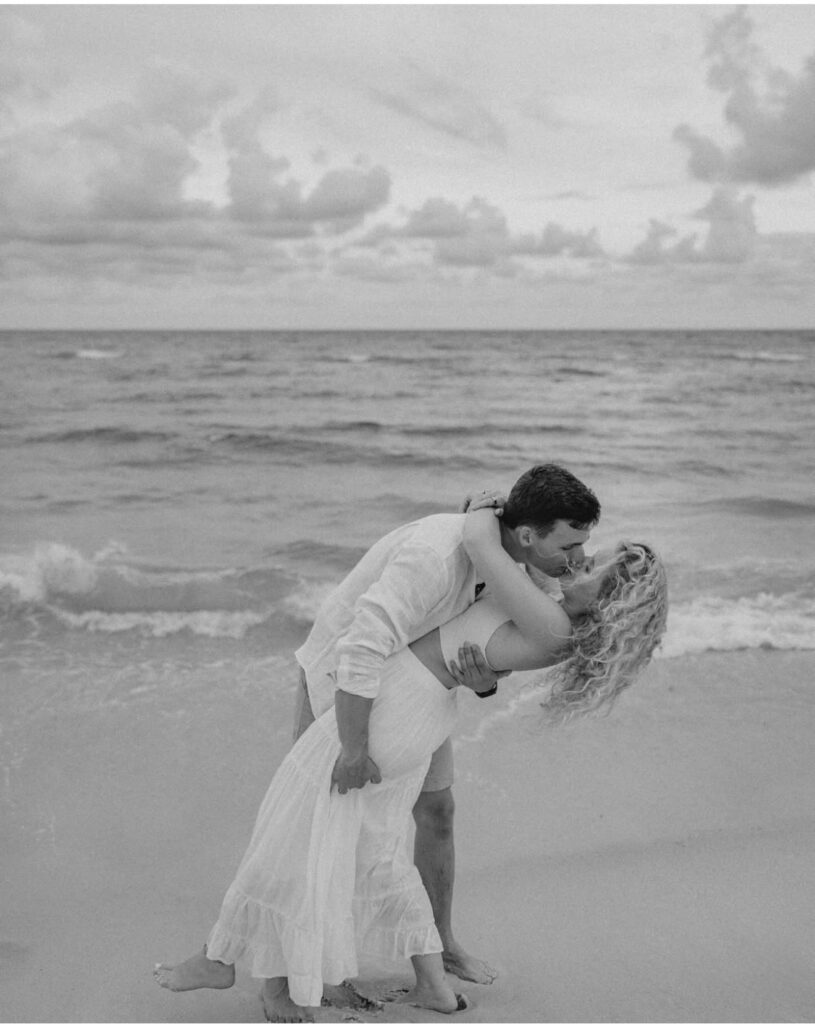 Pensacola wedding venues all inclusive with Palafox Wharf Waterfront Wedding Venue’s couple on the beach in Pensacola FL in a romantic embrace