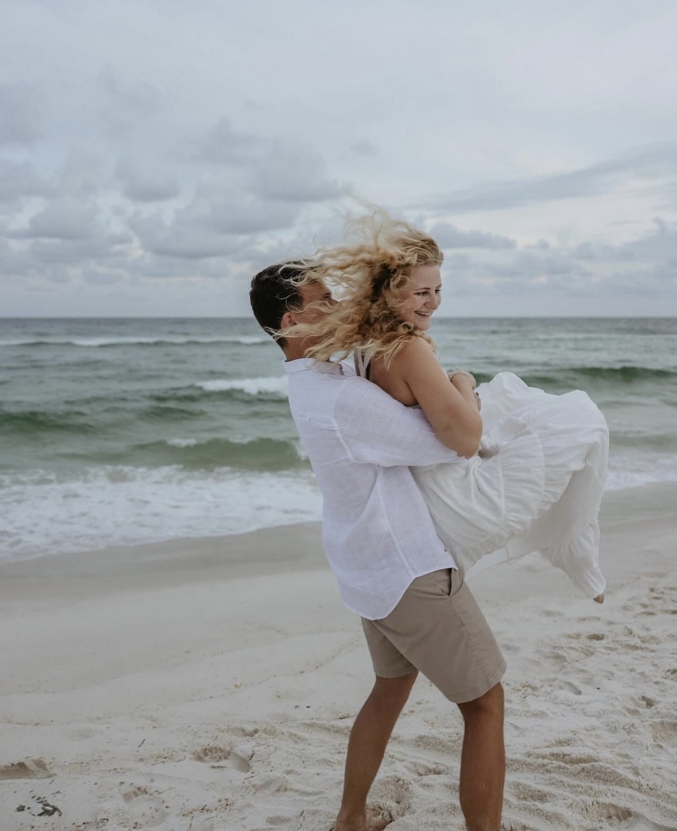 Wedding Venue Pensacola showing bride and groom at beach for photoshot