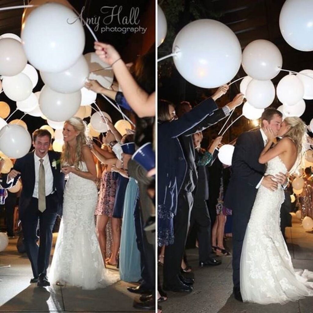 Small Wedding Venues Pensacola FL featuring this Wedding Couple for their Grand Exit showing helium balloons with bride in white dress and laughing along with groom in black suite and brown tie