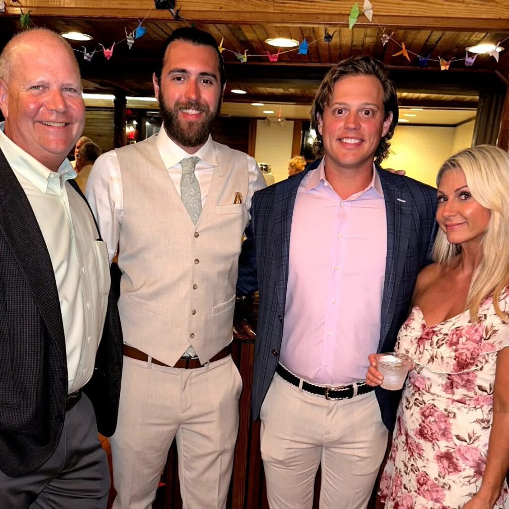 Wedding Venue Pensacola showing guests at a Wedding Celebration for their fellow doctors having been married With 4 guests 3 of which are men and one blond woman guests