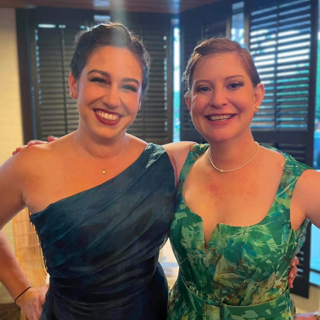 Wedding Venues Pensacola showing guests at a Wedding Celebration for their fellow doctors having been married And they are in blue evening gown and a green dress