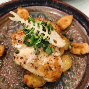 Best Restaurants Near Me - Grouper Piccata with lemon butter sauce and hand-crafted fish scale garnish created by one of the best Chefs in Pensacola for romantic date nights, group dining, and rehearsal dinners.

