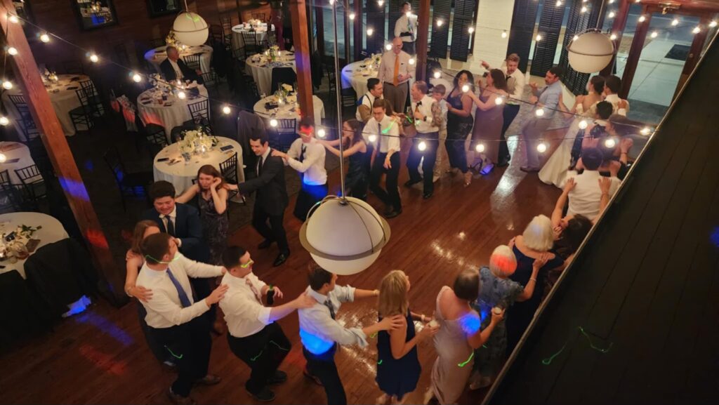 Wedding Venue Pensacola at Palafox Wharf Waterfront Wedding Venue showing wedding group dancing together on the dance floor