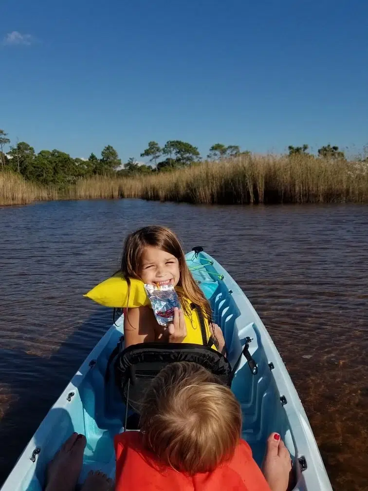 It is great being out on the water and this is in the lake dunes with a little girl holding up an item and she and her mom saw pensacola wedding venues for her mom's wedding