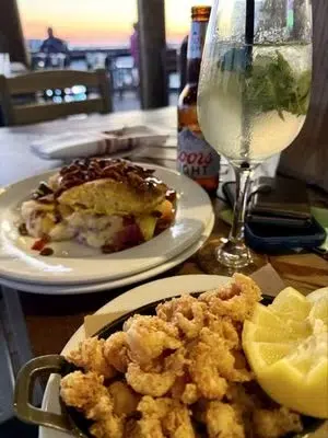 Dine with a white wine and fresh seafood after you tour wedding venues Pensacola