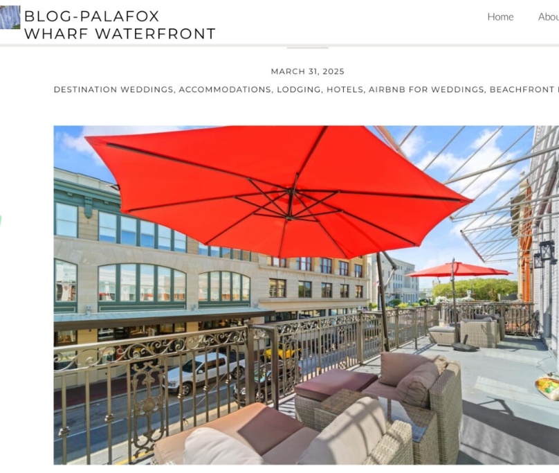 Balcony lounge near downtown wedding venues in Pensacola with red umbrellas and street views