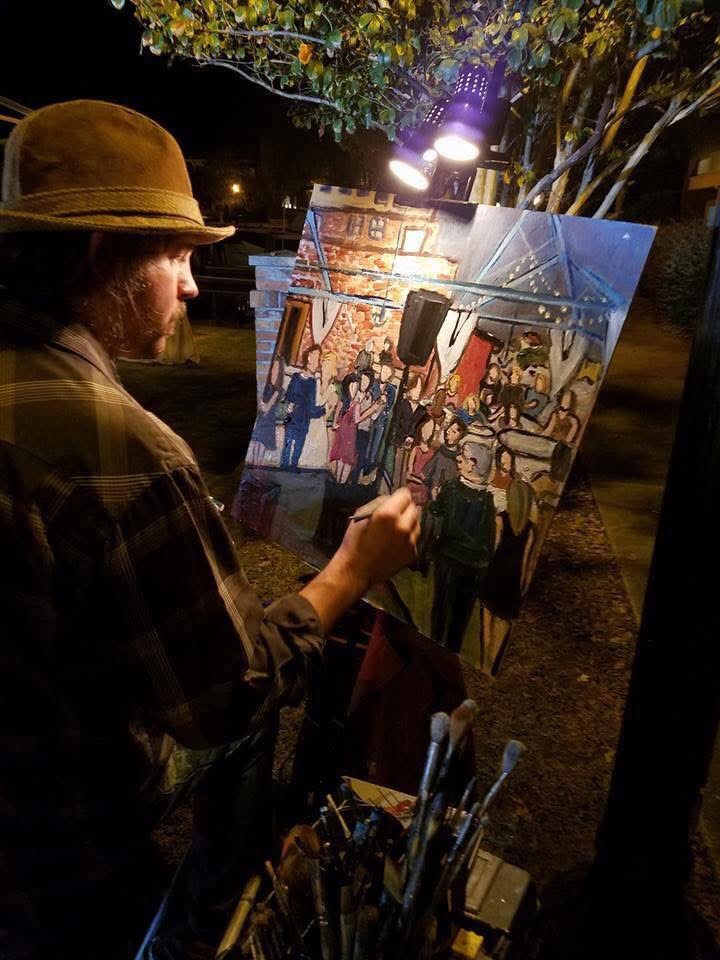 wedding venues near me with artist painting a lively edding scene.