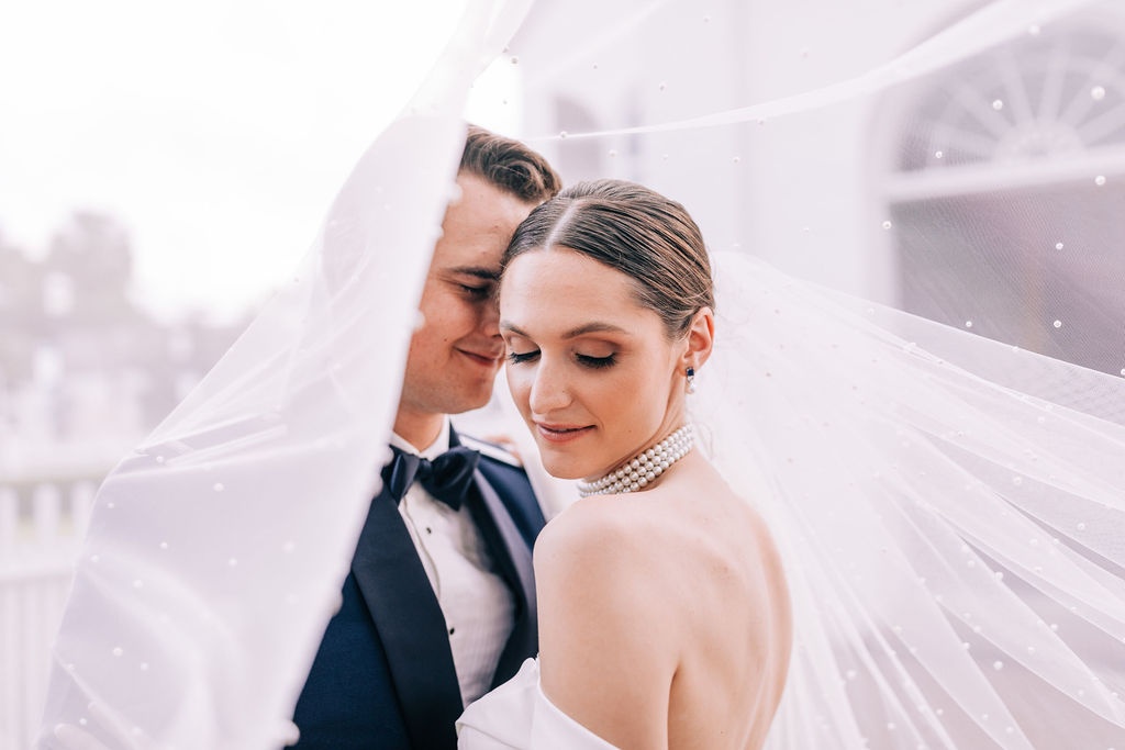 wedding halls in florida with elegant couple under a wedding veil.